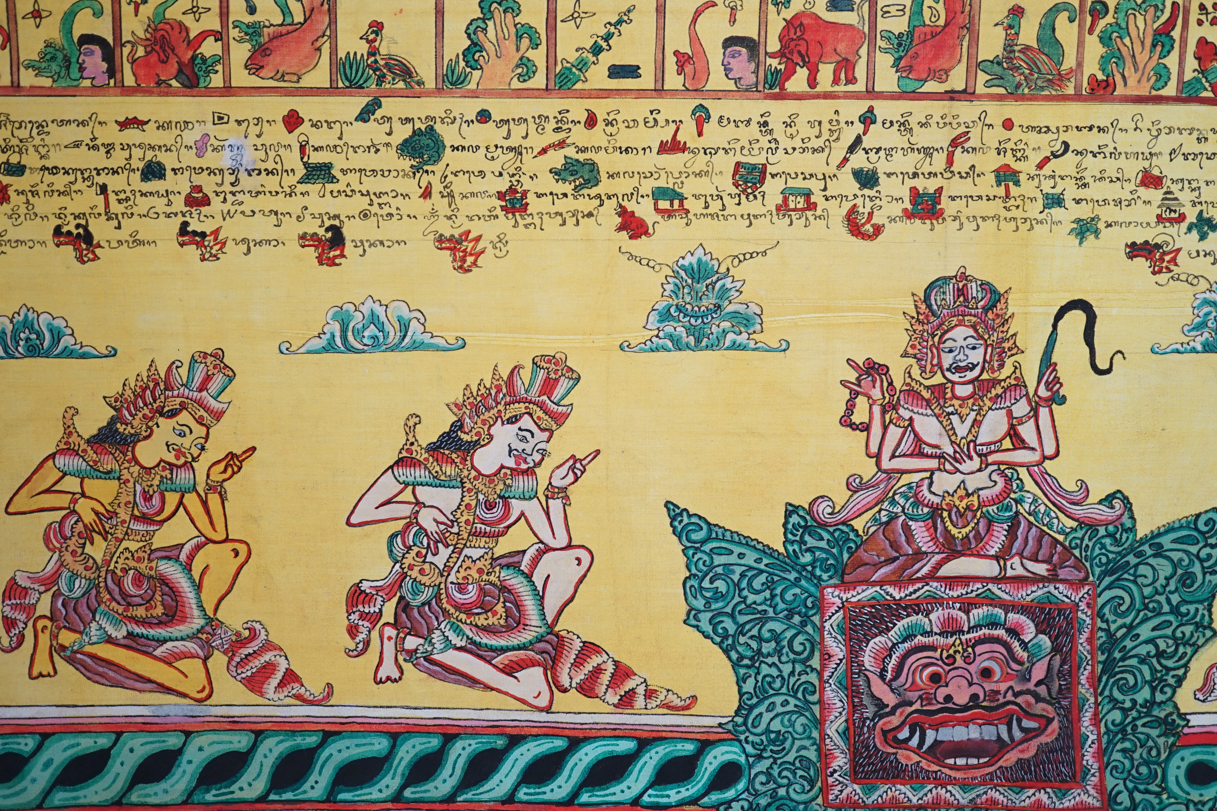 An Indonesian hand painted calendar and two similar figures, tallest 21cm